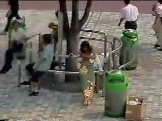 Changing in the street - Japanese young lady in public first part