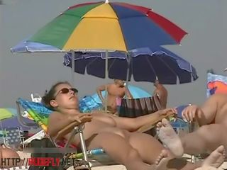A dapper chick in a nude beach spy cam video